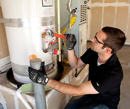 plumber handles water heater repair in Concord by tightening intake line
