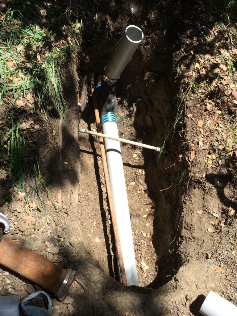 Trenchless sewer repair in progress as a sewer pipe replacement tool is inserted in a small opening dug into the ground in Concord CA