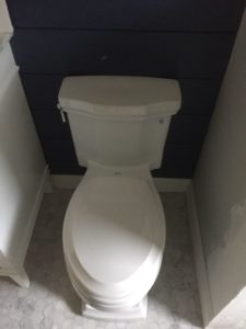 new white toilet provided by customer installed to a small half bathroom